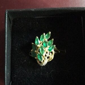 14k Gold Ring with 10 Green Pedals sold to me as Emeralds and tiny diamond chip.